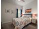 Bedroom featuring a floral patterned bed, bedside tables with lamps, and pictures on the wall at 7432 Paradiso Dr, Apollo Beach, FL 33572