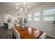 Open-concept dining area with a view into the modern kitchen, a wooden table, and six chairs at 7432 Paradiso Dr, Apollo Beach, FL 33572