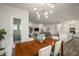 Open layout dining area showcasing modern lighting, wood table, and seamless flow to the kitchen at 7432 Paradiso Dr, Apollo Beach, FL 33572