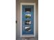 Inviting front door with square glass panels and clean white trim offers a glimpse of the interior at 7432 Paradiso Dr, Apollo Beach, FL 33572