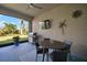 Outdoor lanai featuring a ceiling fan, a television, grill, and a view of the landscaped backyard at 7432 Paradiso Dr, Apollo Beach, FL 33572