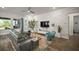 Modern living room featuring a stone accent wall, stylish furnishings, and ample natural light at 7432 Paradiso Dr, Apollo Beach, FL 33572