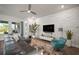 Contemporary living room with a white stone wall, sleek furniture, and open design at 7432 Paradiso Dr, Apollo Beach, FL 33572