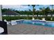 A modern pool design with in-pool seating, a neutral paver deck, and lush tropical landscaping at 7432 Paradiso Dr, Apollo Beach, FL 33572