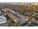 Scenic aerial view of a condo complex with a pool, surrounded by lush trees and city buildings at 800 S Dakota Ave # 205, Tampa, FL 33606