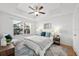 Inviting bedroom featuring a ceiling fan, natural light, and a cozy seating area at 800 S Dakota Ave # 205, Tampa, FL 33606