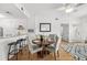 Inviting dining area featuring a round wood table, upholstered chairs, and bar seating at the kitchen counter at 800 S Dakota Ave # 205, Tampa, FL 33606