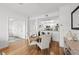 Cozy dining area with a round wood table and upholstered chairs, open to the kitchen with white cabinets at 800 S Dakota Ave # 205, Tampa, FL 33606