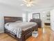 A primary bedroom features hardwood floors, a ceiling fan, and a large dark wood bedroom set at 8448 Fantasia Park Way, Riverview, FL 33578