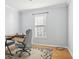 A sparsely decorated office with a desk, chair and a small window with blinds at 8448 Fantasia Park Way, Riverview, FL 33578