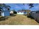 Wide view of the backyard with ample lawn space and sheds at 904 W Braddock St, Tampa, FL 33603