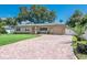 Attractive single story with brick driveway and a well maintained lawn at 9838 53Rd N Ave, St Petersburg, FL 33708