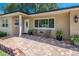 Inviting front porch with brick pavers, comfortable seating, and decorative plants enhancing curb appeal at 9838 53Rd N Ave, St Petersburg, FL 33708