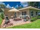 Outdoor patio with a grill, table, and chairs for relaxing and entertaining in a private backyard at 9838 53Rd N Ave, St Petersburg, FL 33708