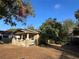 A sunny view of the house from the side, framed by trees against a clear blue sky at 101 W Fern St, Tampa, FL 33604