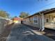 Long driveway leads to a two car garage in back of the house with gutters along the house's edge at 101 W Fern St, Tampa, FL 33604