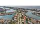 Aerial view of a waterfront community with winding canals, bridges and homes with Gulf access at 10100 Paradise Blvd, Treasure Island, FL 33706