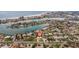 Aerial view of a waterfront community showcasing the home's location near a bay and a beach at 10100 Paradise Blvd, Treasure Island, FL 33706