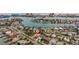 Aerial view of a waterfront community showcasing the home's prime location with beautiful water views at 10100 Paradise Blvd, Treasure Island, FL 33706