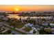 Stunning aerial view of a waterfront community at sunset at 10100 Paradise Blvd, Treasure Island, FL 33706