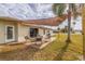 Backyard patio area with outdoor seating under a shade sail and a view of the surrounding neighborhood at 10100 Paradise Blvd, Treasure Island, FL 33706