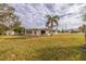 Expansive backyard featuring a seating area and lush green lawn, perfect for outdoor enjoyment at 10100 Paradise Blvd, Treasure Island, FL 33706