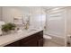 Updated bathroom featuring a white marble countertop, wooden drawers, and a shower-tub combo at 10100 Paradise Blvd, Treasure Island, FL 33706