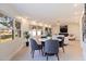 Bright dining room with natural light and an open floor plan, seamlessly connected to the living area, with a plant accent at 10100 Paradise Blvd, Treasure Island, FL 33706