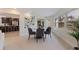 Dining room features a round table with seating for four, with an open design flowing into the kitchen and living space at 10100 Paradise Blvd, Treasure Island, FL 33706