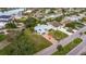 Aerial view of a one-story home with a spacious front yard in a coastal community at 10100 Paradise Blvd, Treasure Island, FL 33706