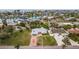 Single story home boasting a well-manicured lawn and a welcoming entrance with an orange door at 10100 Paradise Blvd, Treasure Island, FL 33706