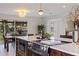 Beautiful kitchen featuring stainless steel appliances, a marble island, and a modern light fixture at 10100 Paradise Blvd, Treasure Island, FL 33706