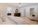 Bright main bedroom with ample closet space, featuring tiled floors, a comfortable chair, and a view into the ensuite at 10100 Paradise Blvd, Treasure Island, FL 33706