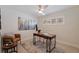 Bright home office featuring a ceiling fan, white walls, a modern desk, and comfortable seating at 10100 Paradise Blvd, Treasure Island, FL 33706