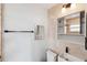 Bathroom with modern sink, tiled backsplash, decorative mirror, and vanity with storage at 1035 County Road 90, Palm Harbor, FL 34684