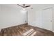 Bedroom with wood-look floors, sliding door closet, neutral walls, and lots of natural light at 1035 County Road 90, Palm Harbor, FL 34684