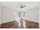 Bright bedroom featuring wood-look floors and natural light from multiple windows at 1035 County Road 90, Palm Harbor, FL 34684