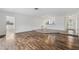 Spacious living room featuring wood flooring, white walls, and an open layout with lots of natural light at 1035 County Road 90, Palm Harbor, FL 34684