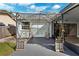 Cozy outdoor patio area with a trellis covered in greenery, offering a charming spot for relaxation at 1035 County Road 90, Palm Harbor, FL 34684