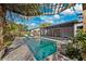 Inviting backyard pool area perfect for relaxing, featuring a pergola and screened-in patio at 1035 County Road 90, Palm Harbor, FL 34684