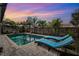 Inviting backyard pool area with brick pavers, sun loungers, and lush tropical landscaping at 1035 County Road 90, Palm Harbor, FL 34684