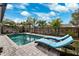 Relaxing backyard pool with blue lounge chairs at 1035 County Road 90, Palm Harbor, FL 34684