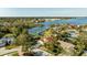 Scenic aerial view of the property with lush landscaping and lake access with private dock at 10562 99Th St, Largo, FL 33773