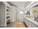 Bright bathroom with double sink vanity, walk-in shower, and arched shelving for linens at 10562 99Th St, Largo, FL 33773