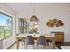 Dining area featuring a wooden table, gray chairs, and view of the outdoors at 10562 99Th St, Largo, FL 33773