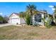 Well-maintained single-story home with a two-car garage, palm trees, and drought-tolerant landscaping at 10562 99Th St, Largo, FL 33773