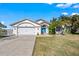 Charming single-story home with well-manicured lawn and attached two-car garage at 10562 99Th St, Largo, FL 33773