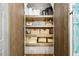 Well-organized linen closet with wooden shelves and ample storage space for toiletries and linens at 10562 99Th St, Largo, FL 33773