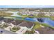 A beautiful aerial view of a lakeside community featuring well-maintained homes and lush landscaping at 10646 Pepper Dawn Cir, San Antonio, FL 33576