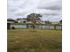 Scenic backyard view featuring a wrought iron fence and a tranquil pond at 10646 Pepper Dawn Cir, San Antonio, FL 33576